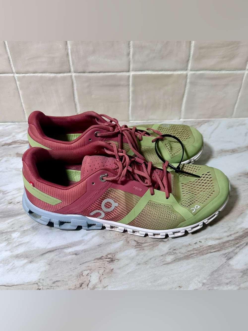 On Cloudflow women's running sneakers in a guava and dust rose colorway